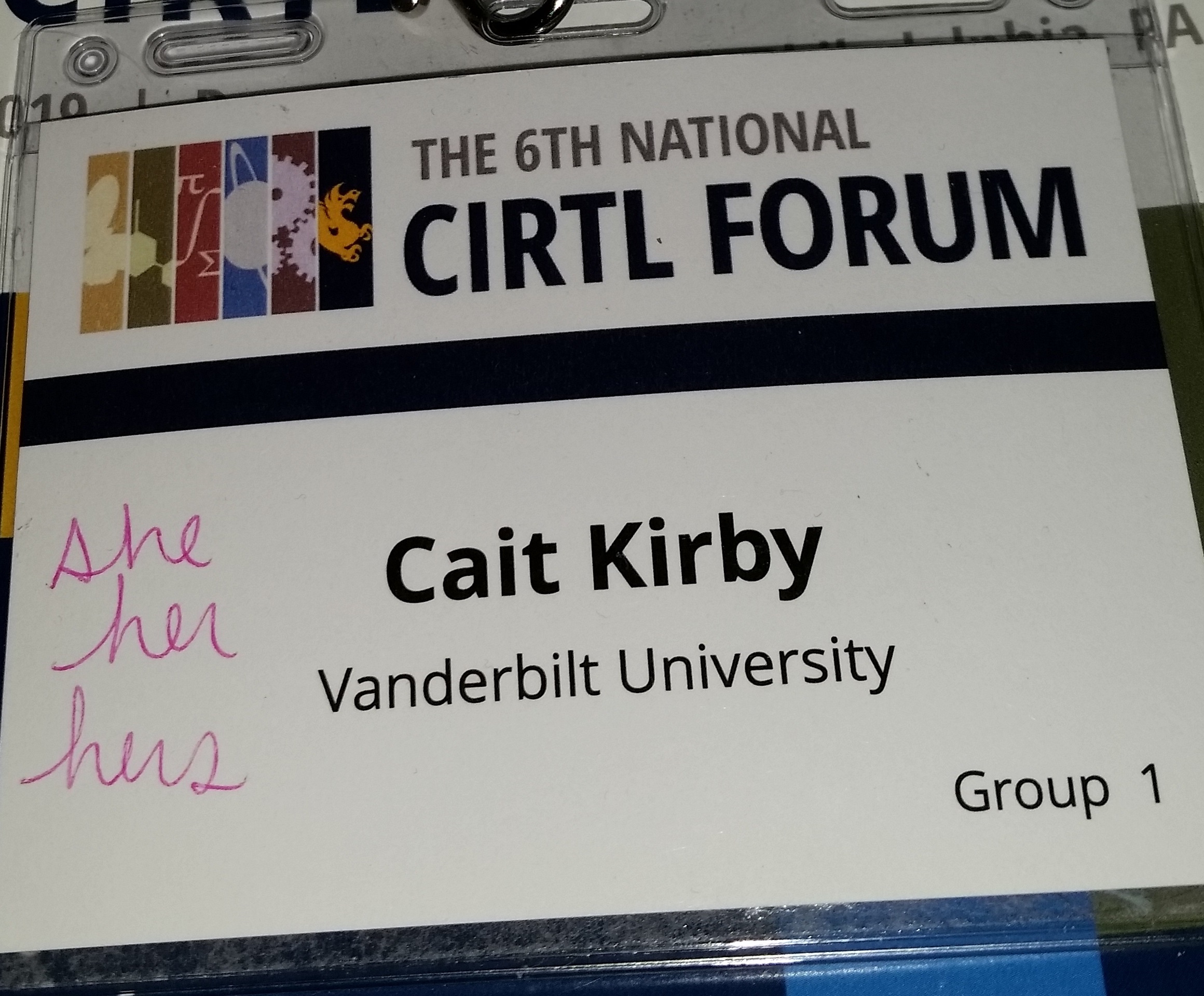 Photo of a nametag from the 2019 CIRTL forum that says Cait Kirby Vanderbilt University in print, and she/her/hers written in pink ink.